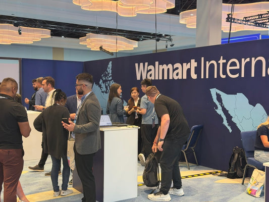 Attendees speaking at the Walmart International exhibit during Walmart Marketplace Let’s Grow! 2026.